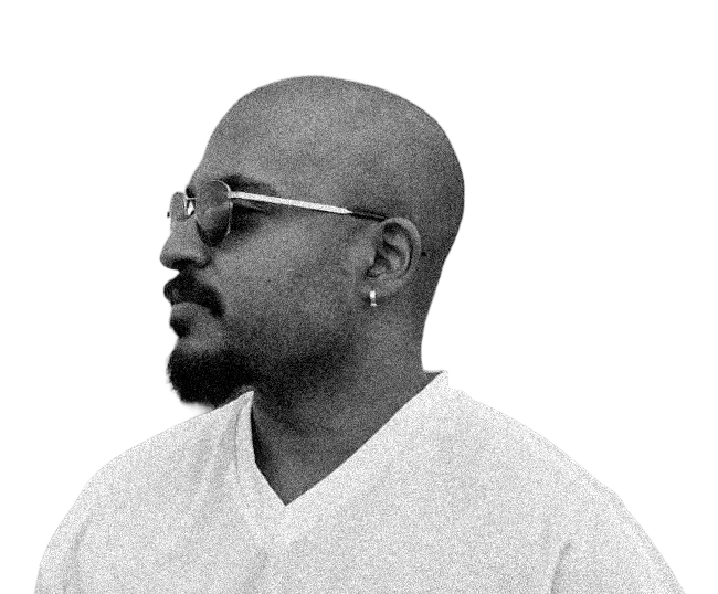Black and white portrait of Abhishek in profile, wearing sunglasses and a white V-neck shirt